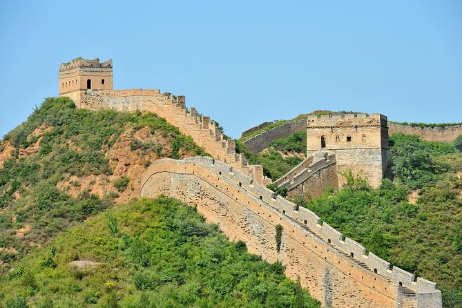 The Great Wall of China running along a wooded ridge north of Beijing